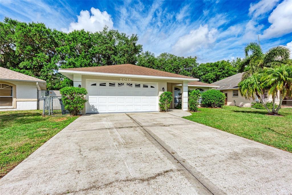 A small entryway features a white front door, a closet door, and wood-look flooring — 2046 OLD TREVOR WAY, SARASOTA, FL