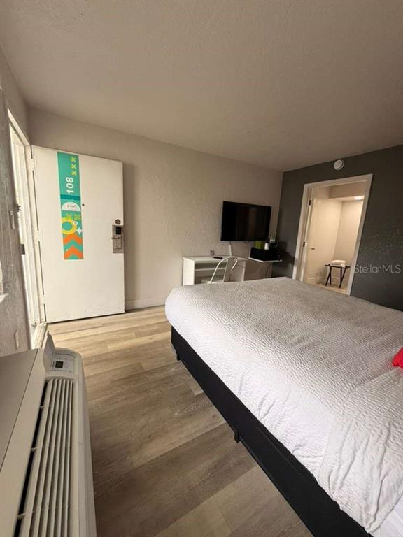 A hotel room features a bed, a desk with a television, and a white door — 5367 W IRLO BRONSON MEMORIAL HIGHWAY UNIT 3-108, KISSIMMEE, FL