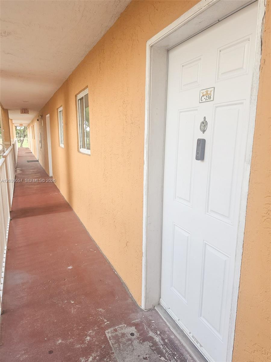 A white door with a smart lock and unit number C-236 sits along an outdoor walkway — 6235 Kendale Lakes Cir # 236, Miami FL 33183, MIAMI, FL