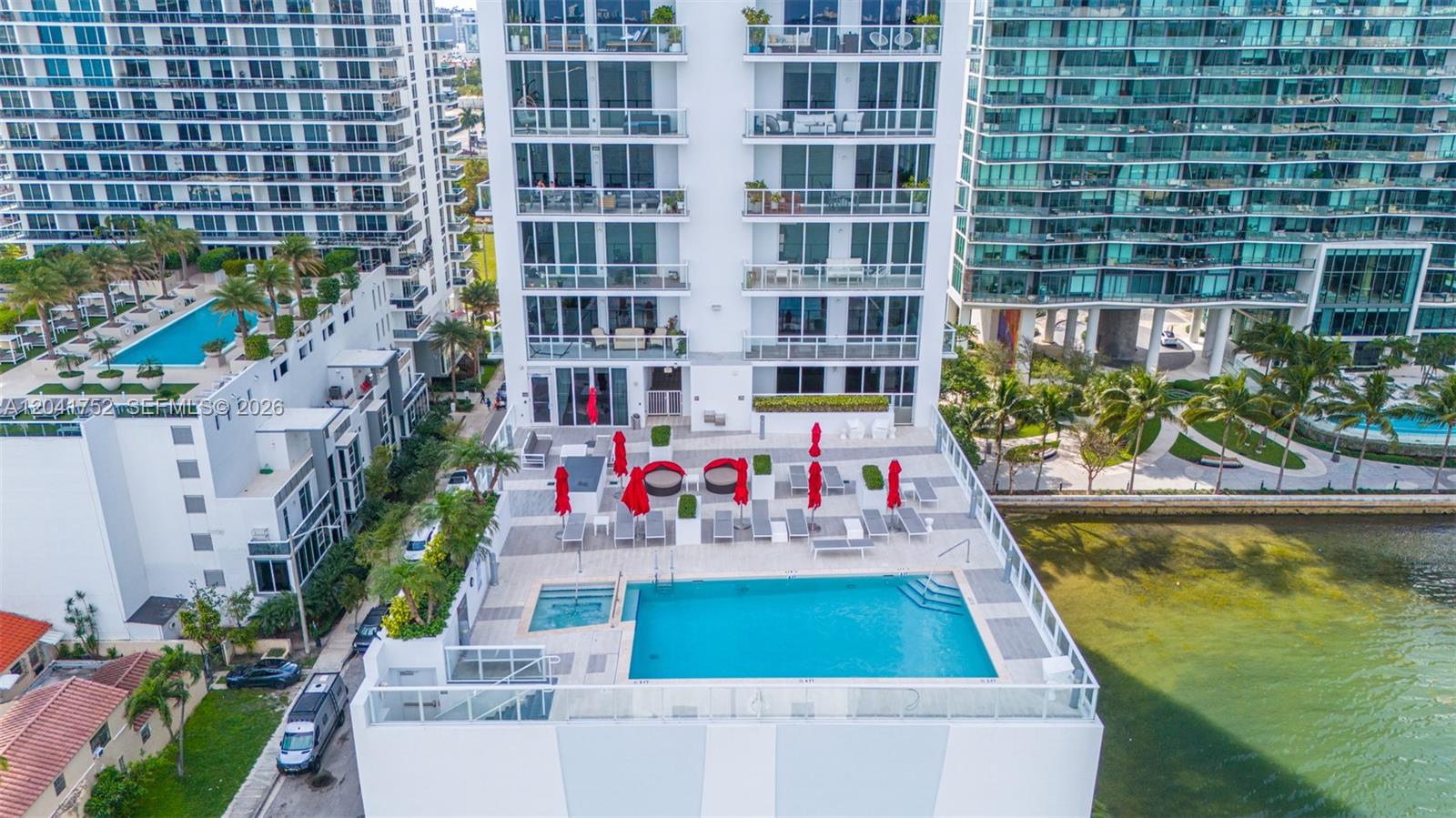 An aerial view shows a swimming pool and patio area at the base of a building — 601 NE 27th St # 1001, Miami FL 33137, MIAMI, FL