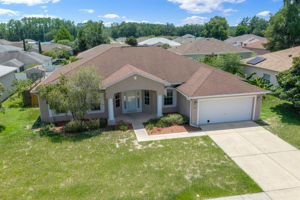 An aerial view of a single-story suburban house with a brown roof and attached garage — 3024 NE 27TH STREET, OCALA, FL