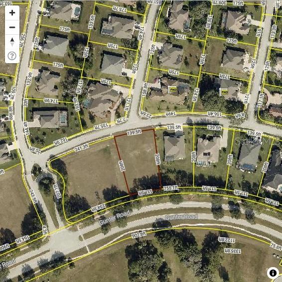 This is an aerial map showing a vacant residential lot highlighted in red — 13822 BASSINGTHORPE DRIVE, SPRING HILL, FL