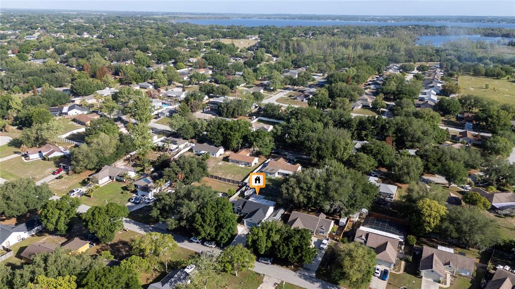 An aerial view shows a residential neighborhood with a house marked by a location pin — 10618 REAGANS RUN DRIVE, CLERMONT, FL