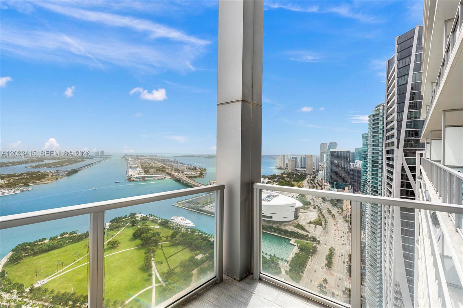 A high-rise balcony overlooks a park, a bay, and the Miami city skyline — 1100 Biscayne Blvd # 5705, Miami FL 33132, MIAMI, FL