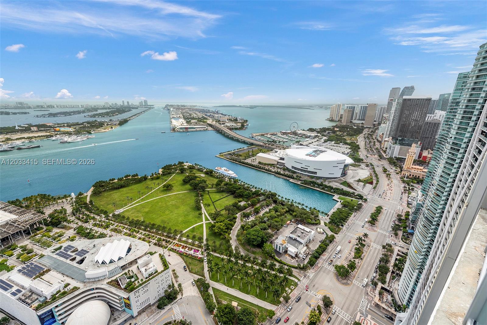 An aerial view shows a park, the Kaseya Center, and a bridge over the water — 1100 Biscayne Blvd # 5705, Miami FL 33132, MIAMI, FL