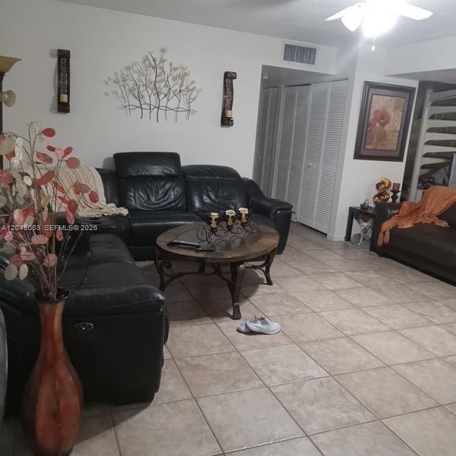 A living room features black leather sofas, a round coffee table, and tile flooring — 8301 SW 157th Ave # 206, Miami FL 33193, MIAMI, FL