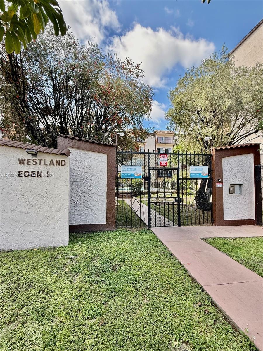 A gated entrance with a sign reading Westland Eden leads to a residential apartment complex — 1950 W 54th St # 115, Hialeah FL 33012, HIALEAH, FL