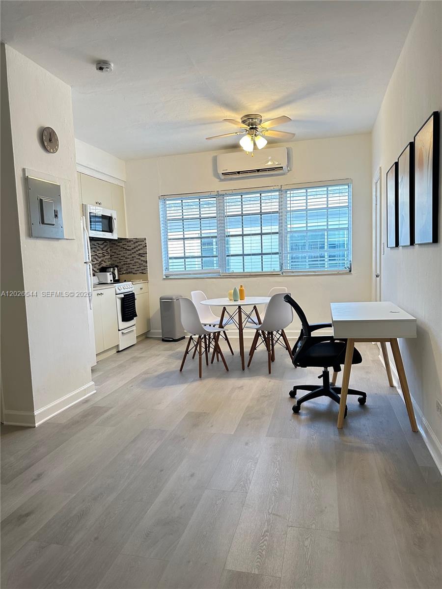 This room features a kitchen area, a dining set, and a desk on light flooring — 836 10th St # 7, Miami Beach FL 33139, MIAMI BEACH, FL