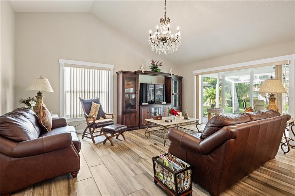 A single-story white house with a light blue garage door and a concrete driveway — 5438 DOMINICA CIRCLE, SARASOTA, FL