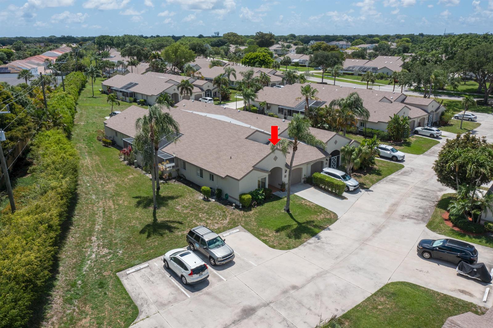 An aerial view shows a single-story residential building with a red arrow pointing toward the roof — 9497 Boca Gardens Parkway # A, Boca Raton FL 33496, BOCA RATON, FL