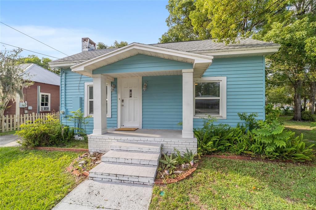 A light blue, single-story house with a covered front porch and white trim — 20837 WALNUT STREET, DUNNELLON, FL