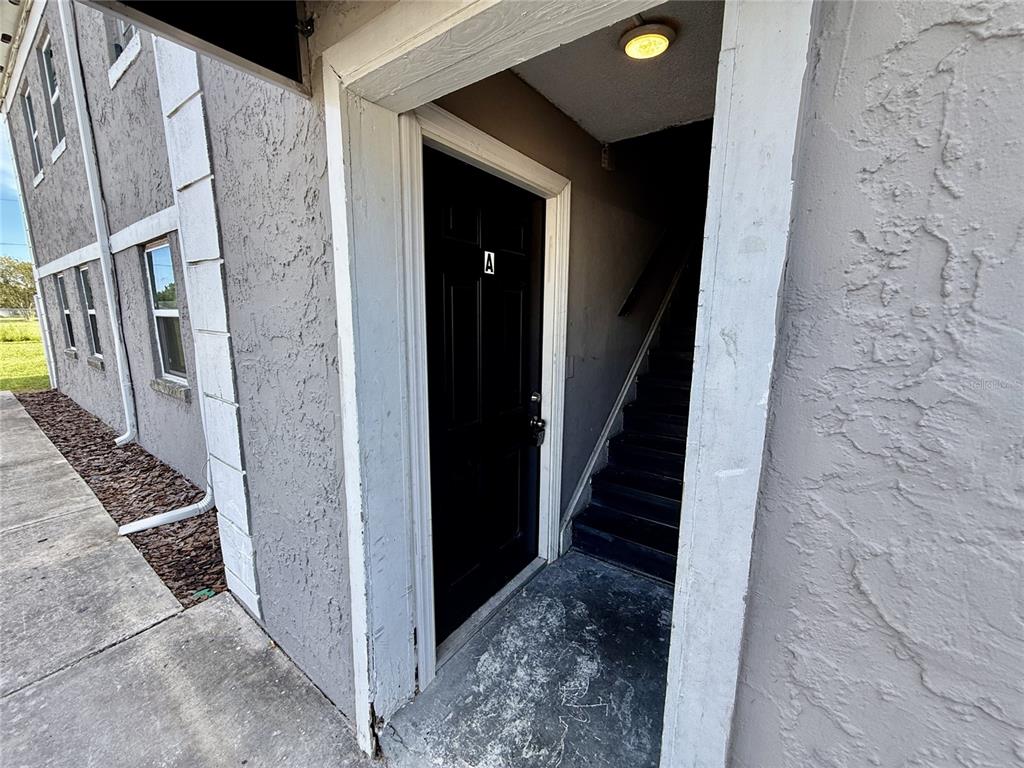 A black door marked with the letter A leads to an interior staircase — 2769 L B MCLEOD ROAD UNIT 2769A, ORLANDO, FL