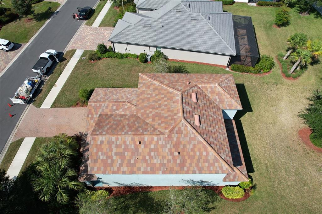 An aerial view shows a house with a multi-colored tile roof and a driveway — 3088 SAGITTARIA LANE, ALVA, FL