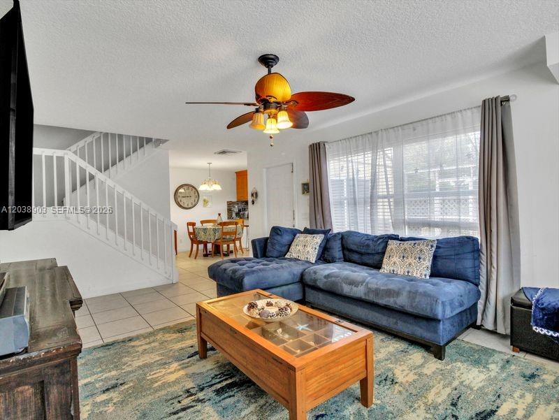 A living room features a blue sectional sofa, a wooden coffee table, and stairs — 6403 Dryden Ct, Boynton Beach FL 33436, BOYNTON BEACH, FL