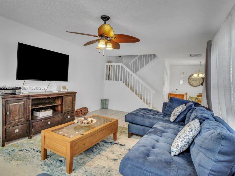 A living room features a blue sectional sofa, a wooden coffee table, and a ceiling fan — 6403 Dryden Ct, Boynton Beach FL 33436, BOYNTON BEACH, FL