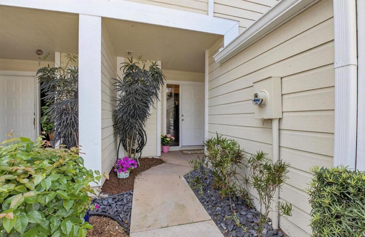 A concrete walkway leads to the front entrance of a house with light-colored siding — 5282 Sapphire Valley, Boca Raton FL 33486, BOCA RATON, FL