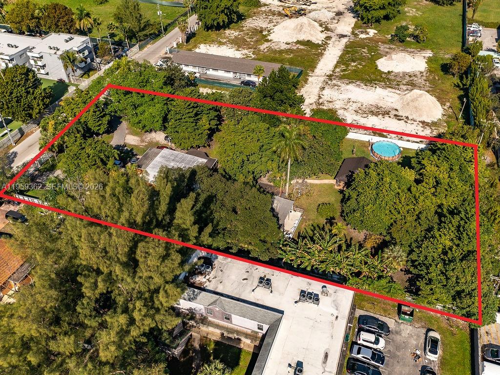An aerial view shows a rectangular lot with trees, two small buildings, and a pool — 13265 Alexandria Dr, Opa-Locka FL 33054, OPA-LOCKA, FL