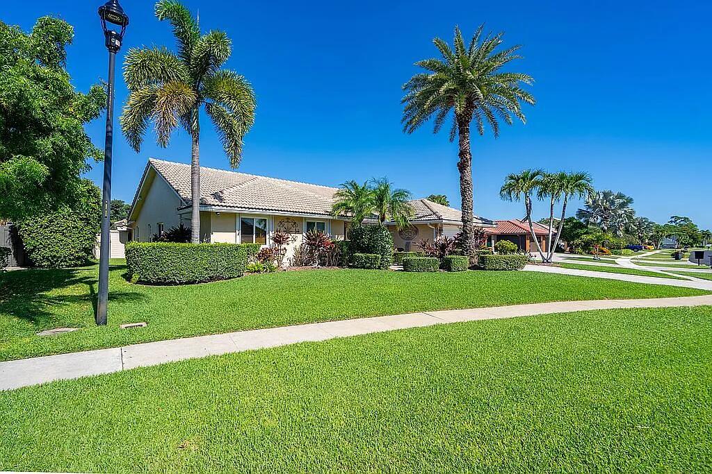 A single-story house with a tiled roof, palm trees, and a manicured lawn — 22373 Ensenada Way, Boca Raton FL 33433, BOCA RATON, FL
