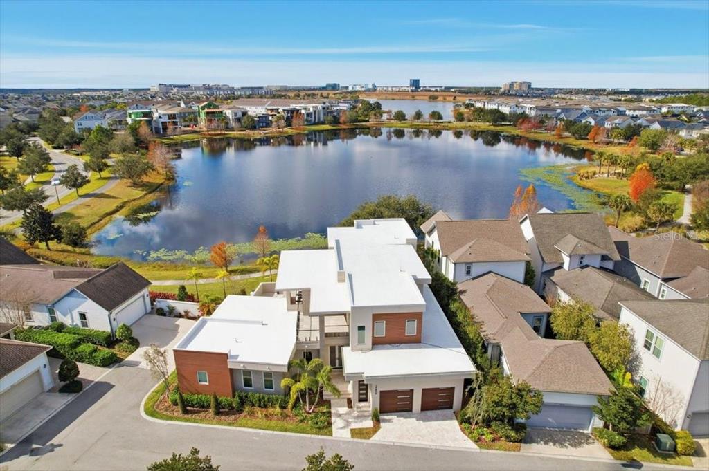 A modern two-story house with a flat roof, balconies, and a landscaped backyard — 13424 BEEBE ALLEY, ORLANDO, FL