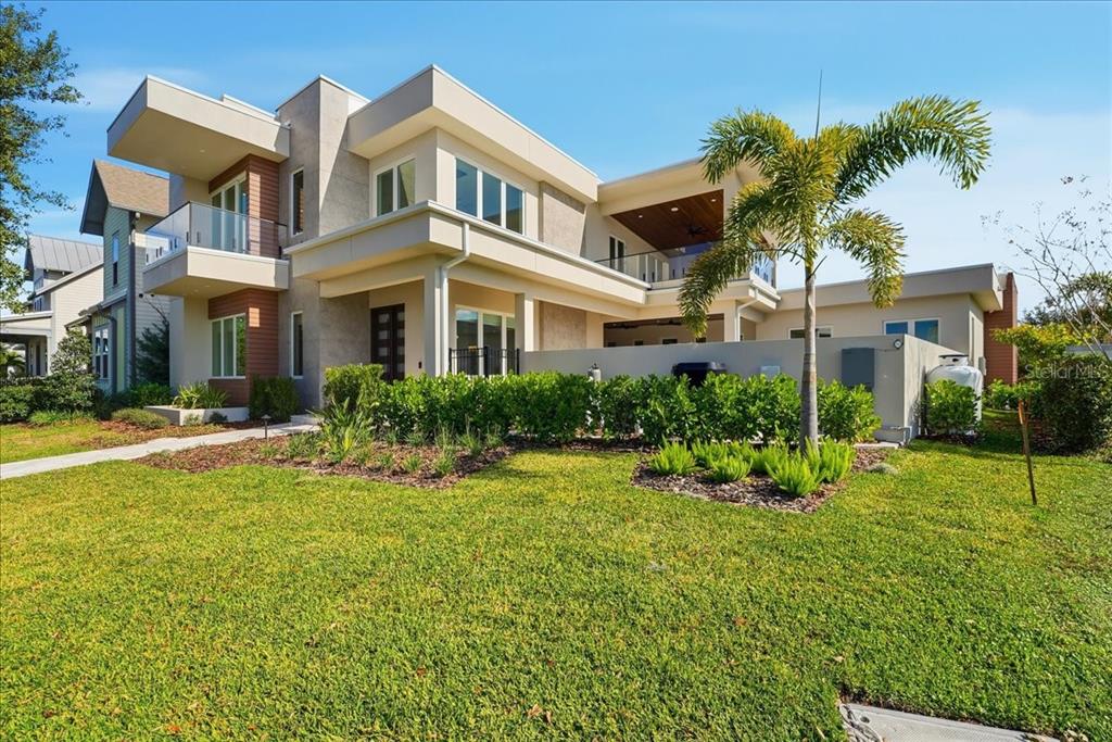 A modern two-story house features a flat roof, balconies, and a landscaped front yard — 13424 BEEBE ALLEY, ORLANDO, FL