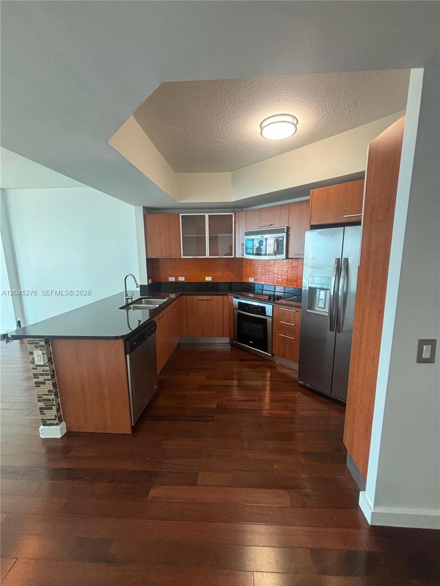 A white stacked washer and dryer unit is located inside a small closet — 480 NE 30th St # 1004, Miami FL 33137, MIAMI, FL