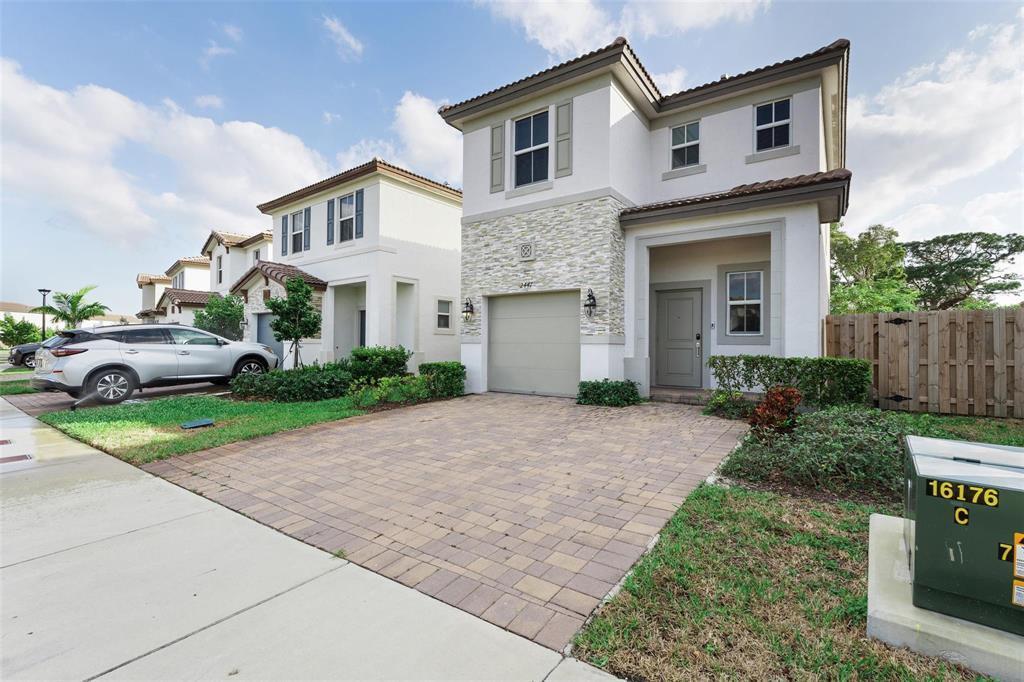 A two-story house with a stone facade, a paved driveway, and a single-car garage — 2441 NW 131st Circle # 2441, Miami FL 33167, MIAMI, FL