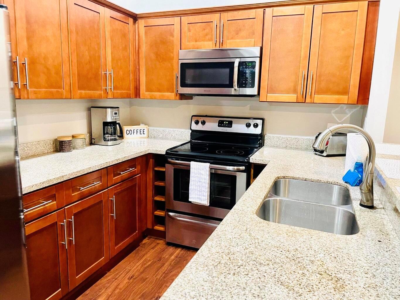 A kitchen with wood cabinets, stainless steel appliances, and granite countertops — 1317 Periwinkle Place, Wellington FL 33414, WELLINGTON, FL