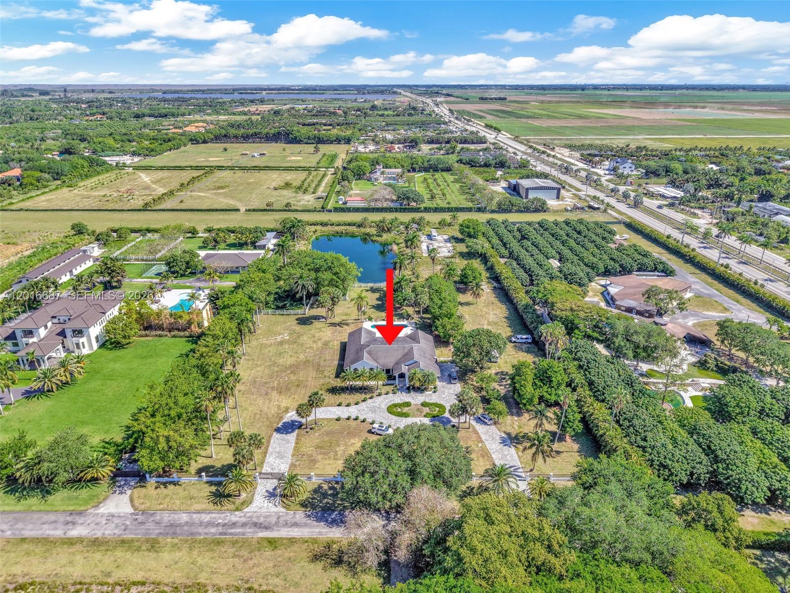An aerial view shows a large house with a pool on a spacious, landscaped lot — 17795 SW 158th St, Miami FL 33187, MIAMI, FL