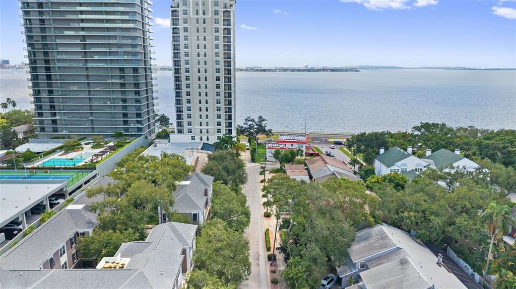An aerial view shows a residential street leading toward a large body of water — 3007 W MASON STREET UNIT A, TAMPA, FL