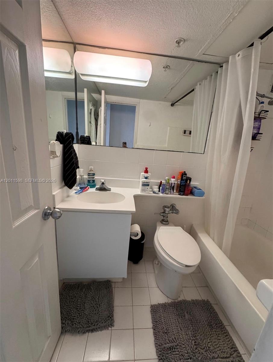A small bathroom features a white vanity, a toilet, and a shower-tub combination — 1500 Bay Rd # 1576S, Miami Beach FL 33139, MIAMI BEACH, FL