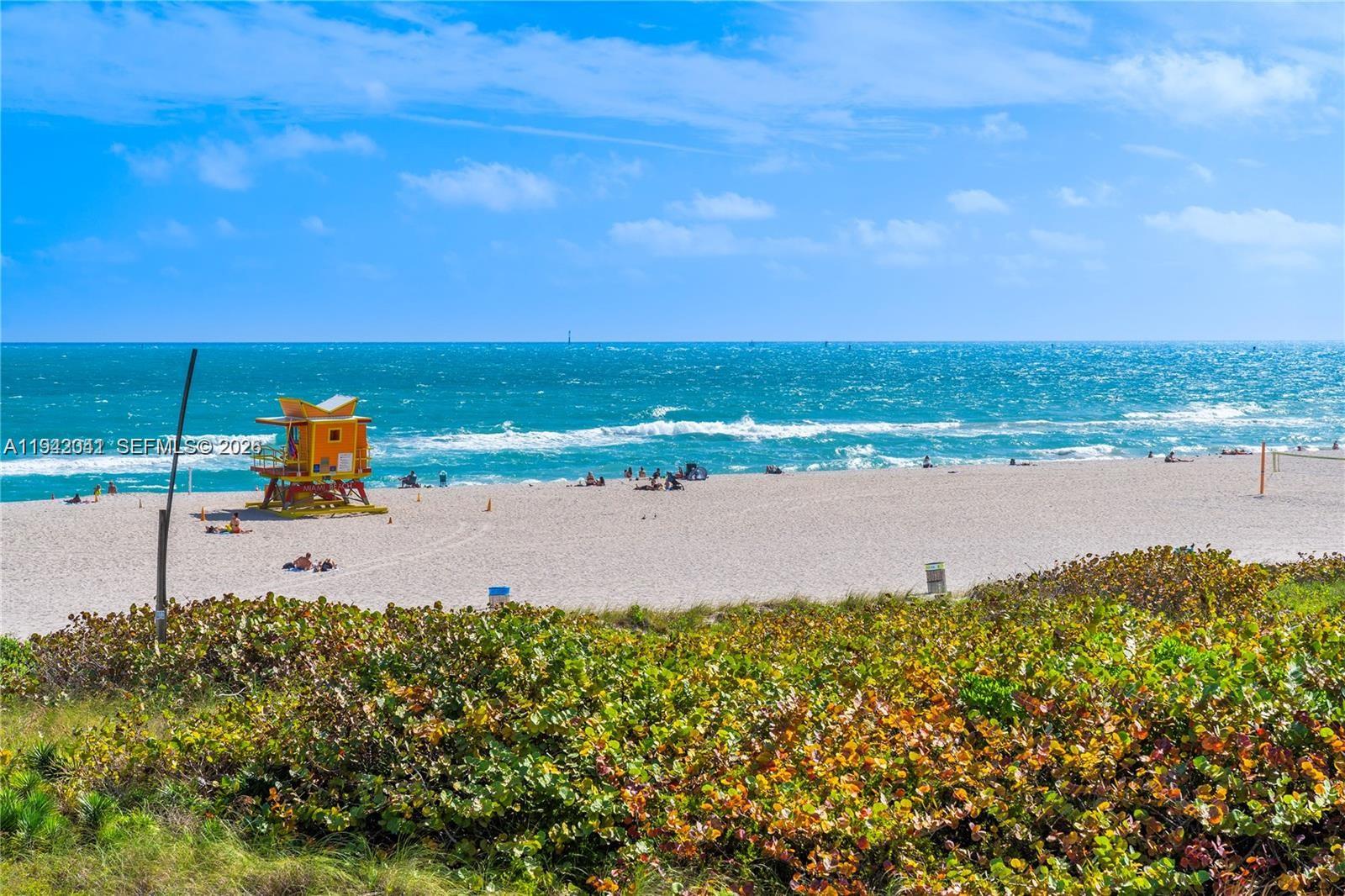A yellow lifeguard tower stands on a sandy beach overlooking the ocean — 301 Ocean Dr # 302, Miami Beach FL 33139, MIAMI BEACH, FL