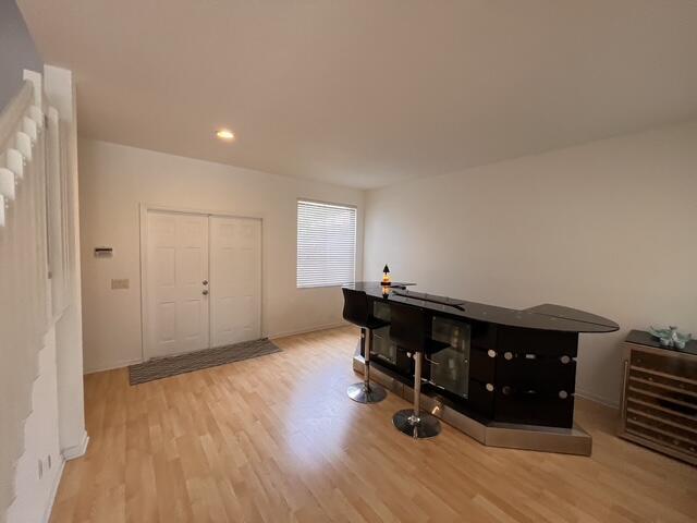 A room with light wood flooring features a black bar set and a double door entrance — 1869 Aspen Lane, Weston FL 33327, WESTON, FL