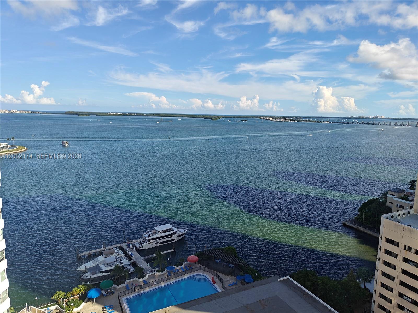 An elevated view of a bay with boats, a swimming pool, and a bridge — 999 Brickell Bay Dr # 1904, Miami FL 33131, MIAMI, FL