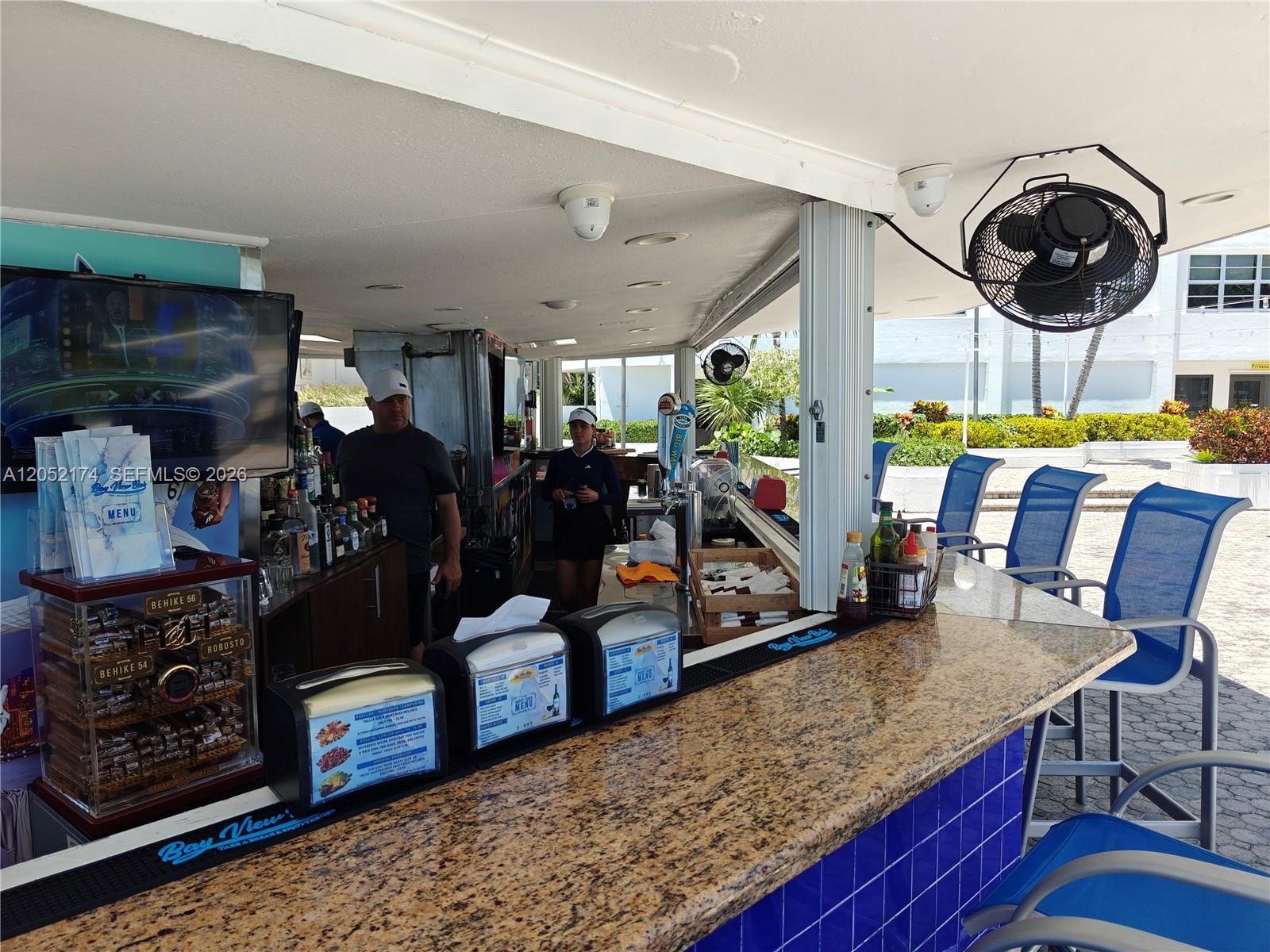 An outdoor bar features a granite countertop, blue tiled base, and several blue chairs — 999 Brickell Bay Dr # 1904, Miami FL 33131, MIAMI, FL