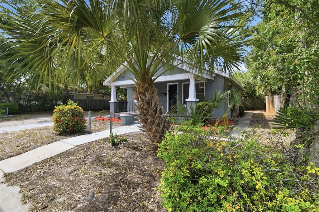 A gray bungalow with a front porch and a palm tree in the yard — 2550 10TH AVENUE S, ST PETERSBURG, FL