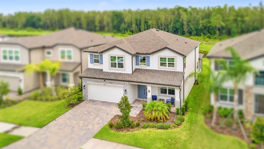 An aerial view of a two-story suburban house with a paved driveway and landscaped yard — 10726 NEW MORNING DRIVE, TAMPA, FL
