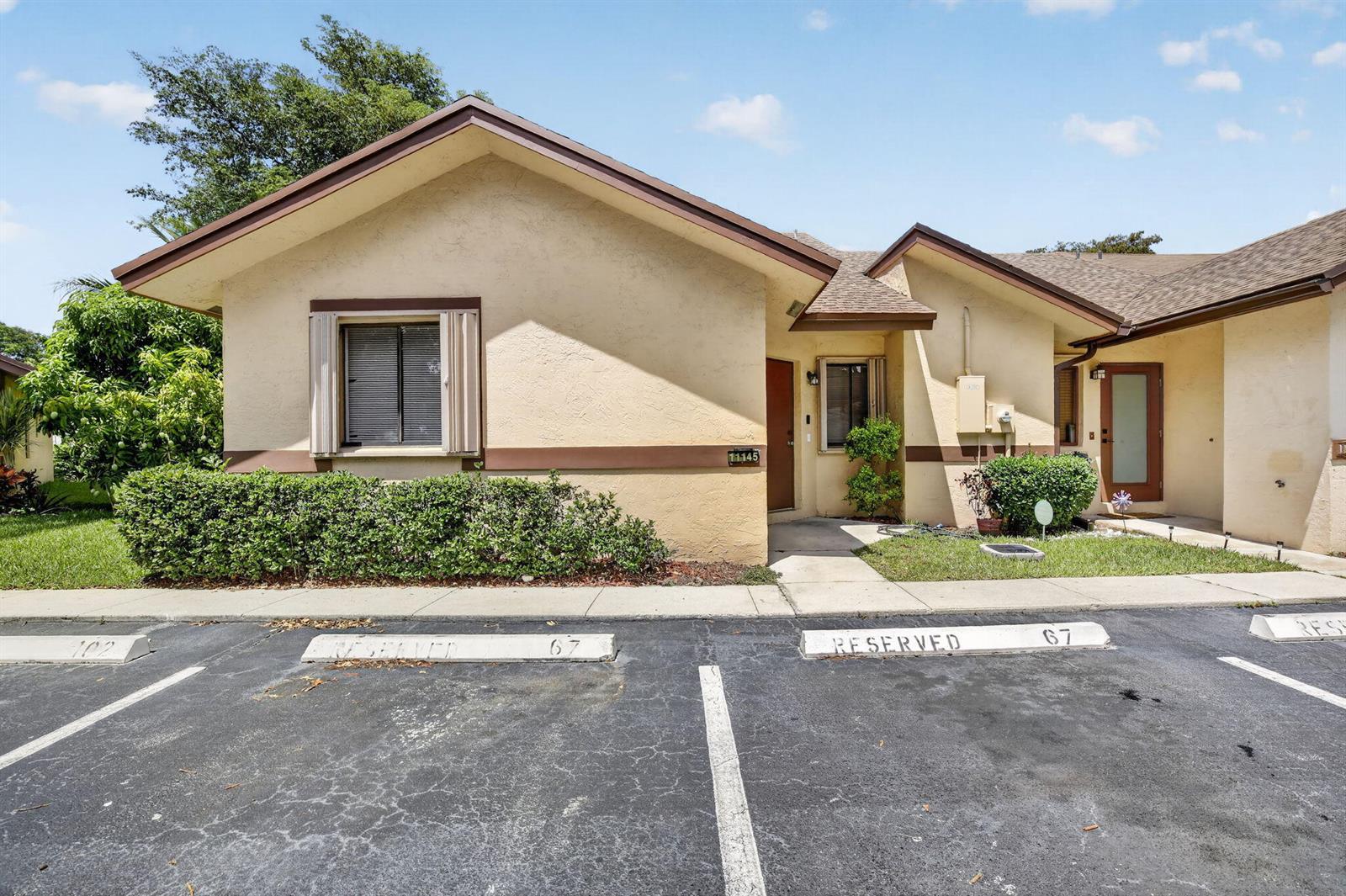 A single-story tan stucco building with a brown roof and two reserved parking spaces — 11145 NW 38th Place, Sunrise FL 33351, SUNRISE, FL