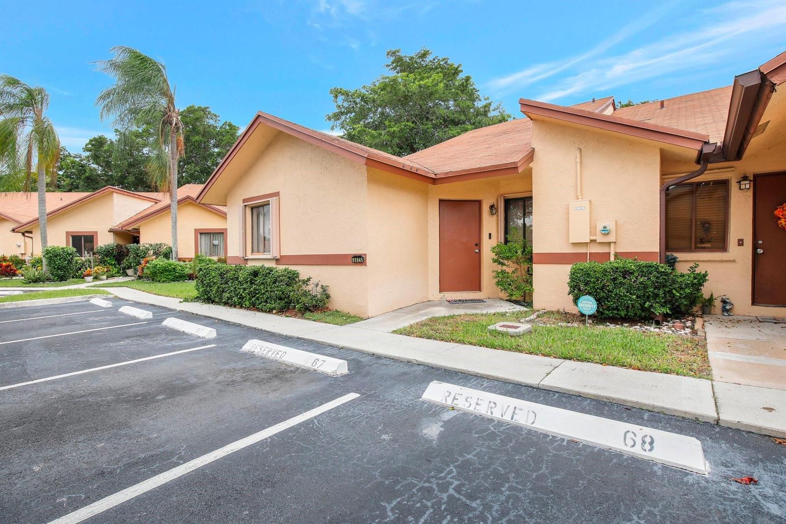 A single-story tan stucco building with a brown roof and reserved parking spaces in front — 11145 NW 38th Place, Sunrise FL 33351, SUNRISE, FL