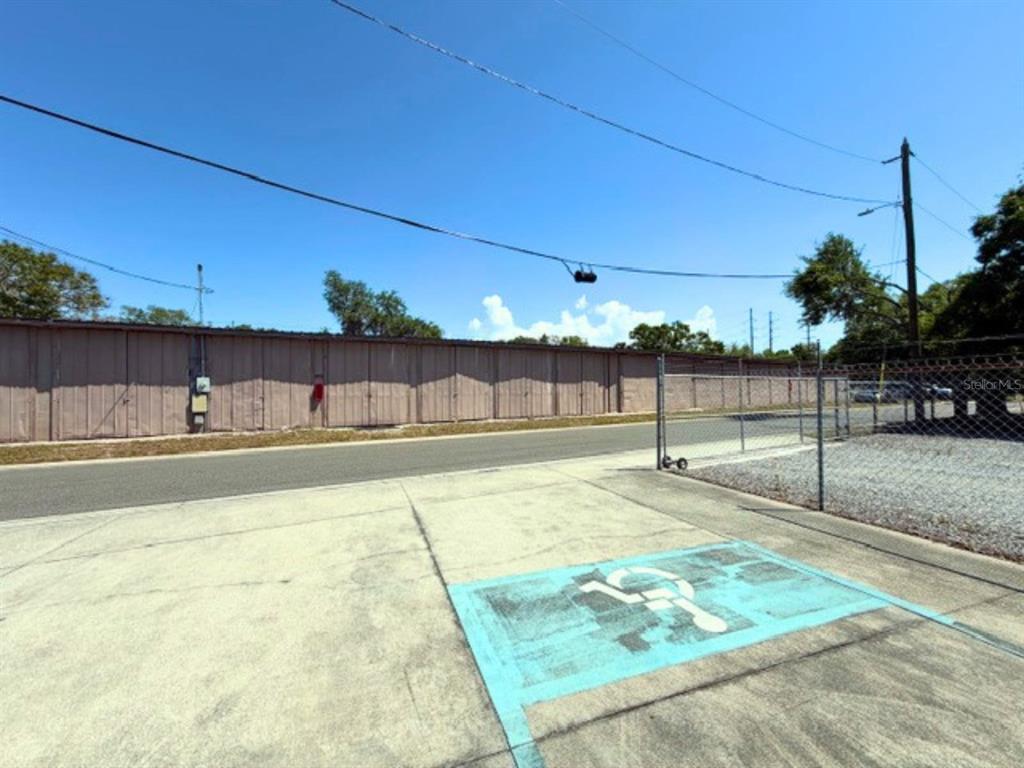 A paved parking lot features a blue handicap symbol in front of a storage facility — 300 12TH STREET SW, LARGO, FL