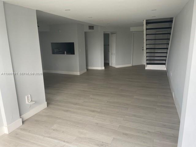 An open-concept living area features light wood-look flooring, recessed lighting, and a staircase — 8305 SW 152nd Ave # 406, Miami FL 33193, MIAMI, FL