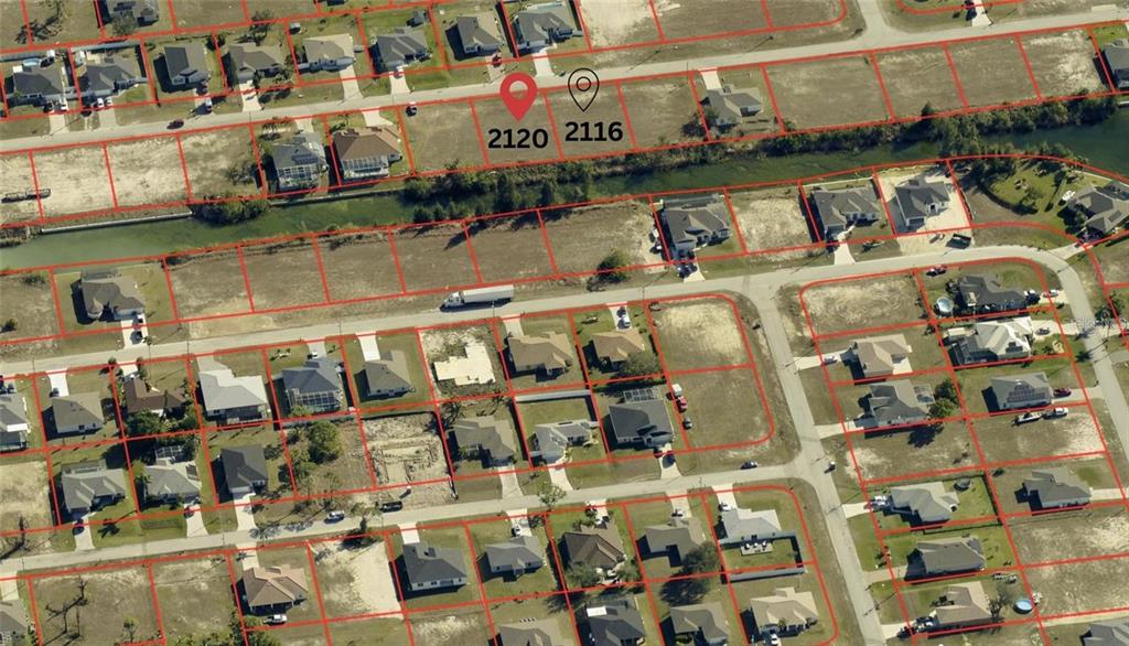 This aerial view shows a residential neighborhood with vacant lots and existing houses — 2120 NW 17TH AVENUE, CAPE CORAL, FL
