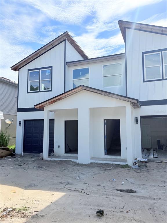 The exterior of a two-story duplex under construction features white siding and dark trim — 3601 N 52ND STREET, TAMPA, FL