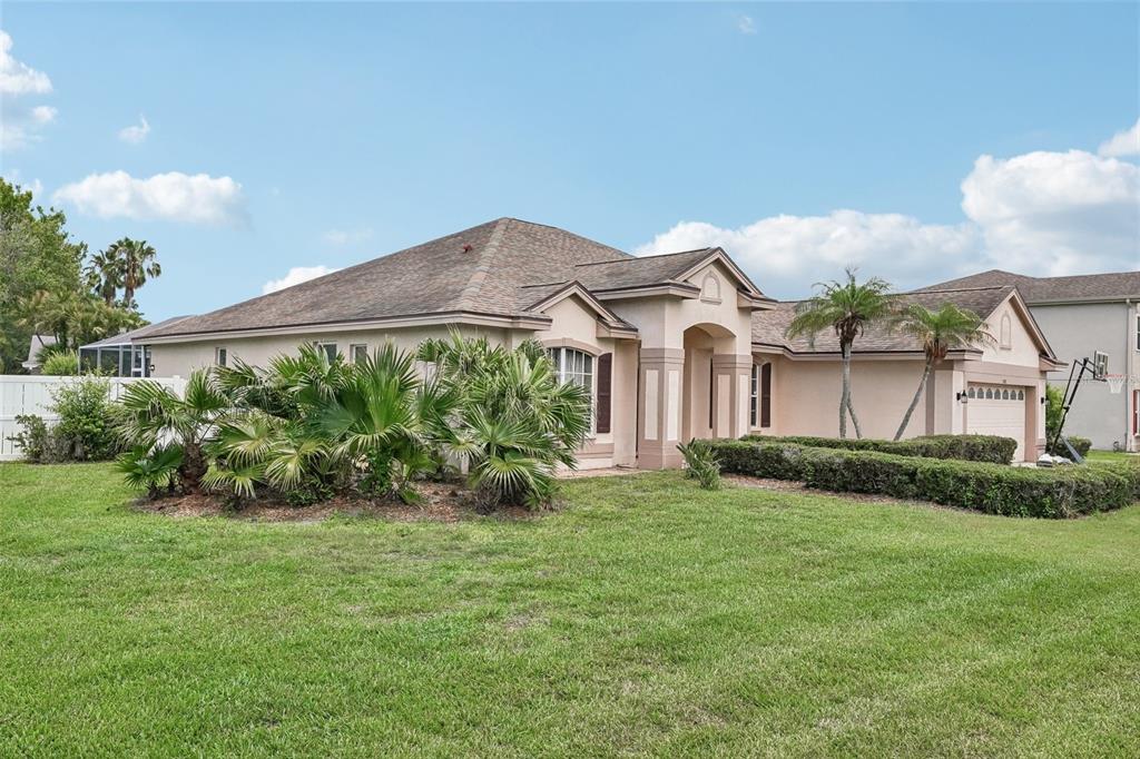A single-story house with a tan exterior, a hip roof, and a front-facing garage — 1008 ROBINWOOD DRIVE, OLDSMAR, FL