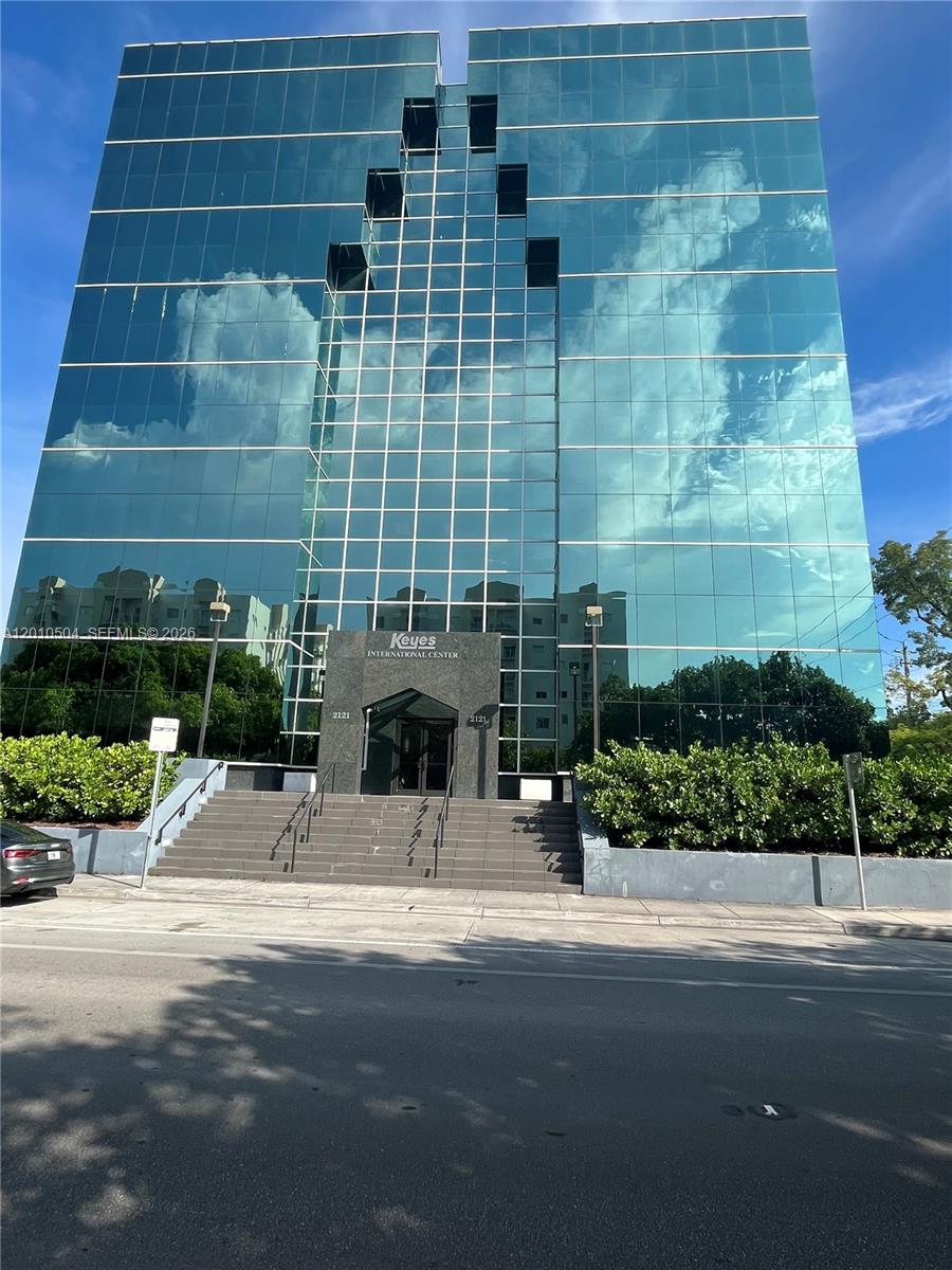 A multi-story glass-facade office building features a central entrance with stairs and dark stone cladding — 2121 SW 3rd Ave # 200, Miami FL 33129, MIAMI, FL