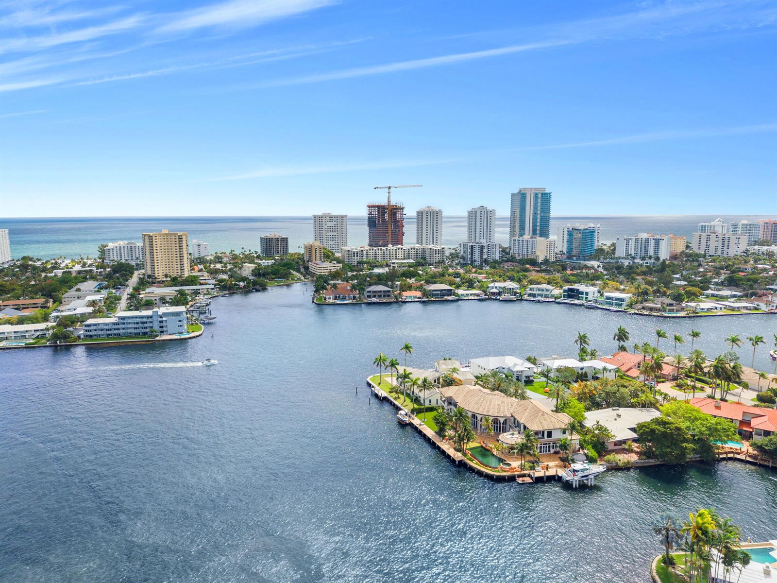 An aerial view shows a waterfront residential area with luxury homes, boats, and distant high-rises — 2593 SE 8th Street, Pompano Beach FL 33062, POMPANO BEACH, FL