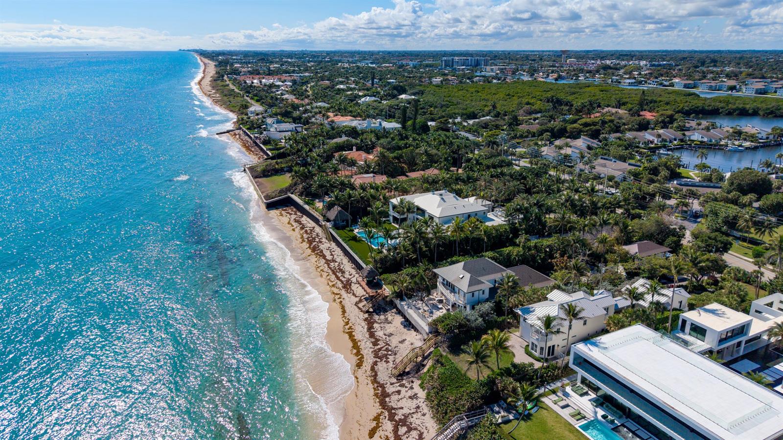An aerial view shows luxury beachfront homes with swimming pools along a sandy coastline — 6201 N Ocean Boulevard, Ocean Ridge FL 33435, OCEAN RIDGE, FL