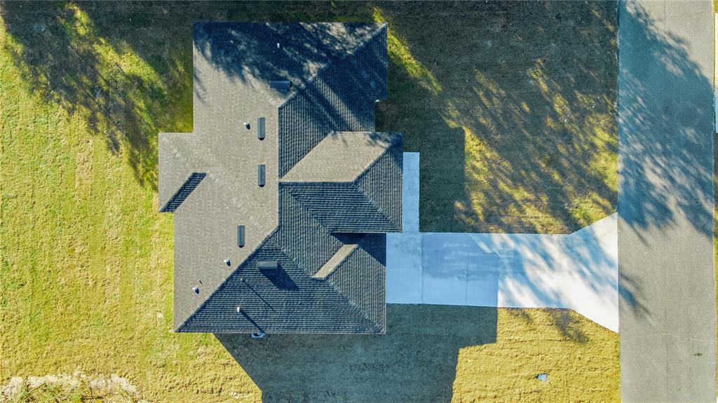 An aerial view shows a house with a dark shingled roof and a concrete driveway — 13690 SW 43RD CIRCLE, OCALA, FL