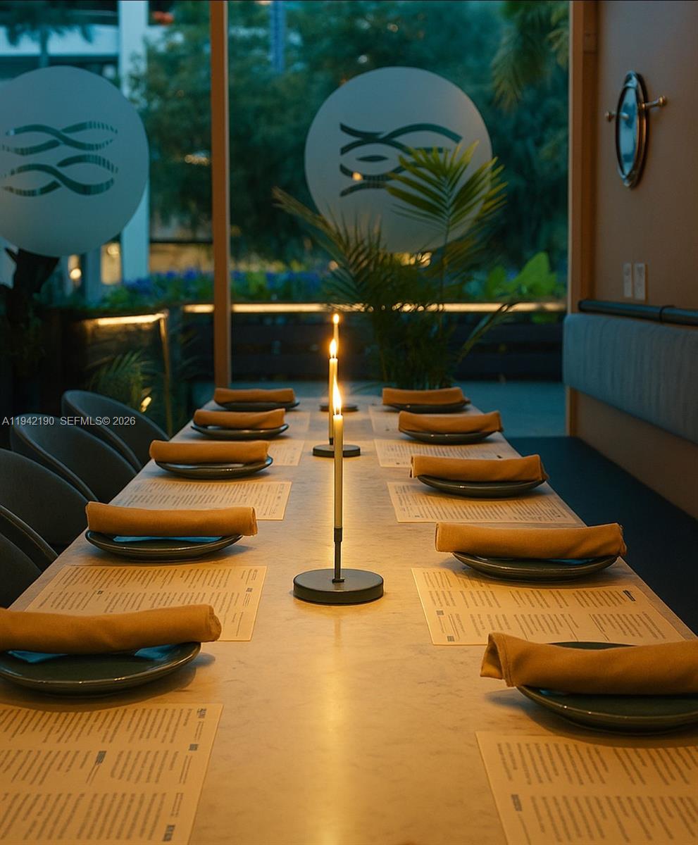 A long dining table is set with place settings and candles in a modern restaurant — 1965 NE 2nd St, Deerfield Beach FL 33441, DEERFIELD BEACH, FL