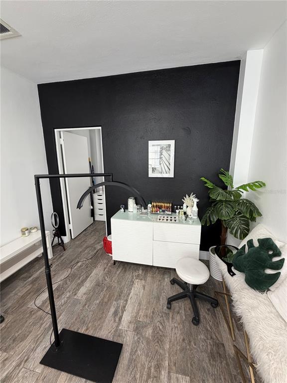 A small room features a black accent wall, a white cabinet, and a professional floor lamp — 320 N MAGNOLIA AVENUE UNIT Suite B4, ORLANDO, FL