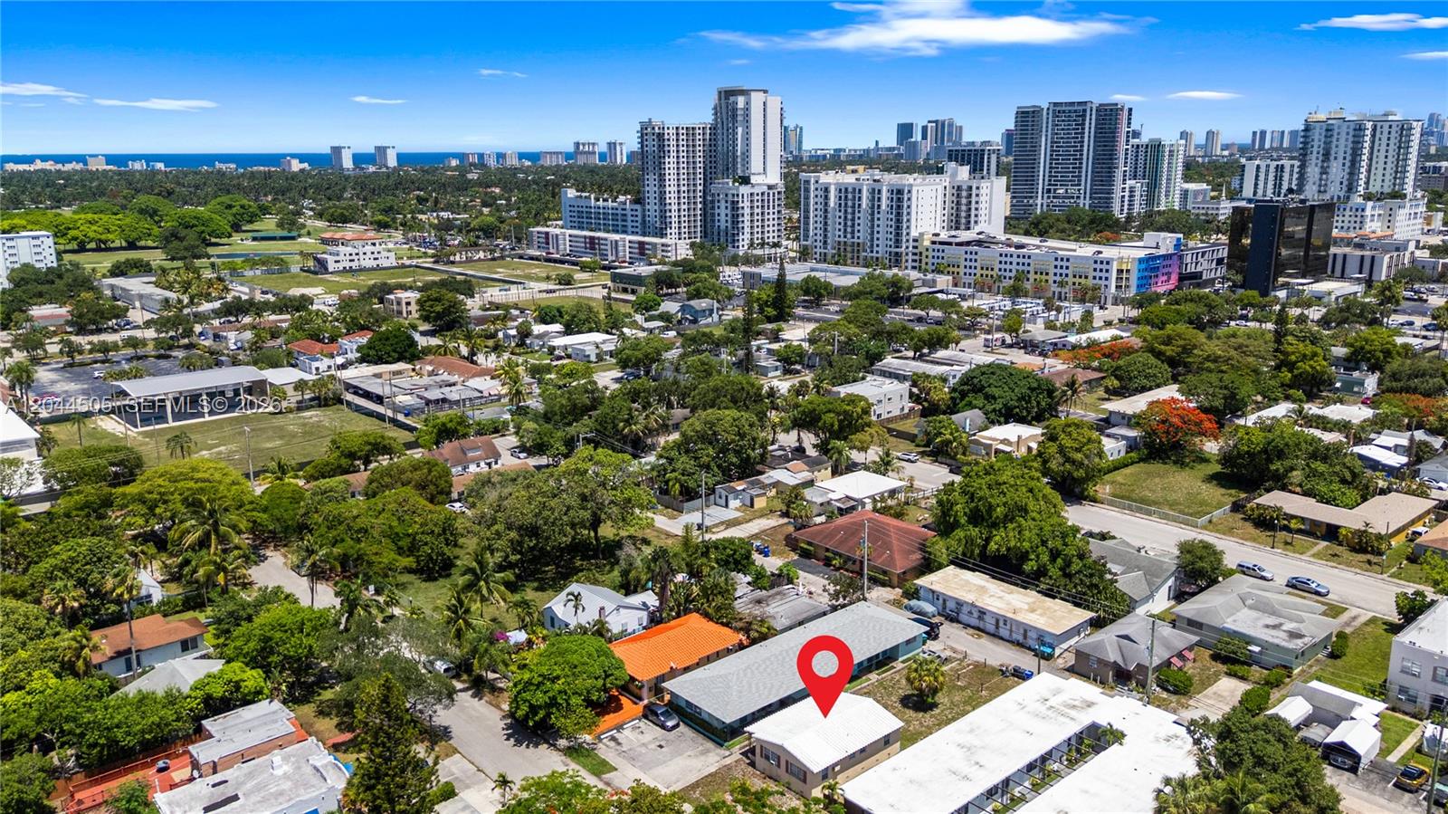 An aerial view shows a residential neighborhood with a red location pin on a building — 1938 Pierce St, Hollywood FL 33020, HOLLYWOOD, FL